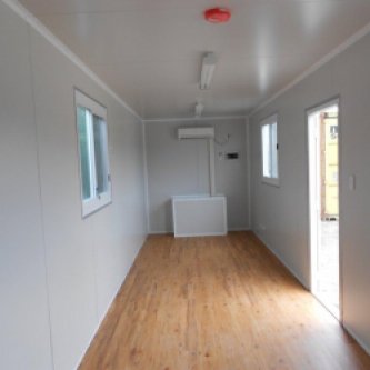 Interior of 40 foot Site Container with Storage Space, Wood floors, White walls